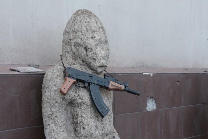 Játékfegyver lóg egy kiállított tárgyon a mariupoli helytörténeti múzeumban 2022. áprili 28-án. Fotó: MTI/AP