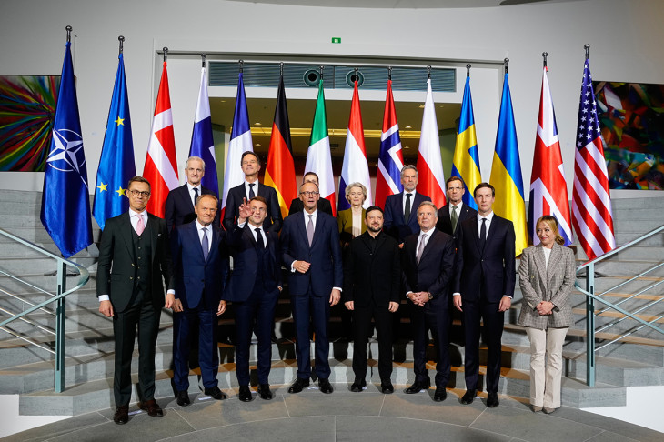 Csoportkép az ukrajnai háború lezárását célzó amerikai kezdeményezésű béketervről tartott tanácskozás résztvevőiről a berlini kancellári hivatalban 2025. december 15-én - az első sorban Macron mutogat, aki már készülhetett a nagy brüsszeli  manőverre