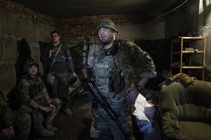Ukrán katonák az ágyúzás végét várják bunkerükben, egy Harkiv térségében húzódó frontszakaszon 2022. július 23-án, az Ukrajna elleni orosz háború alatt. Fotó: MTI/AP/Jevhen Maloletka