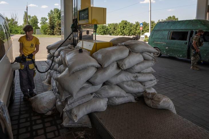 Benzinkutas üzemanyagot tölt egy járműbe Konsztantinovkában 2022. július 15-én, miután orosz rakétatámadás érte a kelet-ukrajnai Donyecki területen fekvő települést. MTI/AP