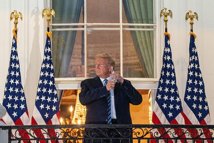 Donald Trump leveszi szájmaszkját, miután visszatért a washingtoni Fehér Házba a Maryland állambeli Bethesdában lévő Walter Reed katonai kórházból 2020. október 5-én. (Fotó: MTI/EPA /Pool/Ken Cenedo)