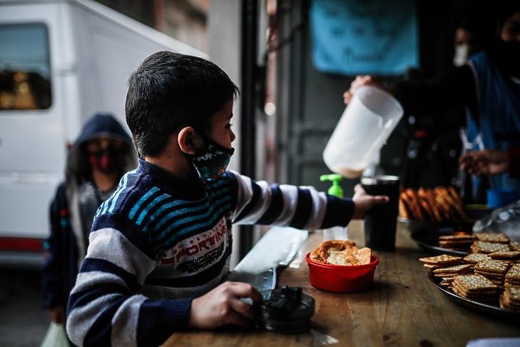 Egy gyerek vár egy pohár tejre egy közösségi élelmezési helyen Argentína fővárosában, Buenos Airesben 2020. július 29-én. Latin-Amerikában, amelyet nagy mértékben sújt a vírusválság, 11 millió embert fenyeget az éhínség hivatalos becslések szerint. EPA/Juan Ignacio Roncoroni