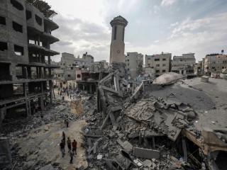 Palesztinok sétálnak az izraeli légicsapások által lerombolt épületek romjai között Gázavárosban 2023. október 9-én. Fotó: EPA/MOHAMMED SABER